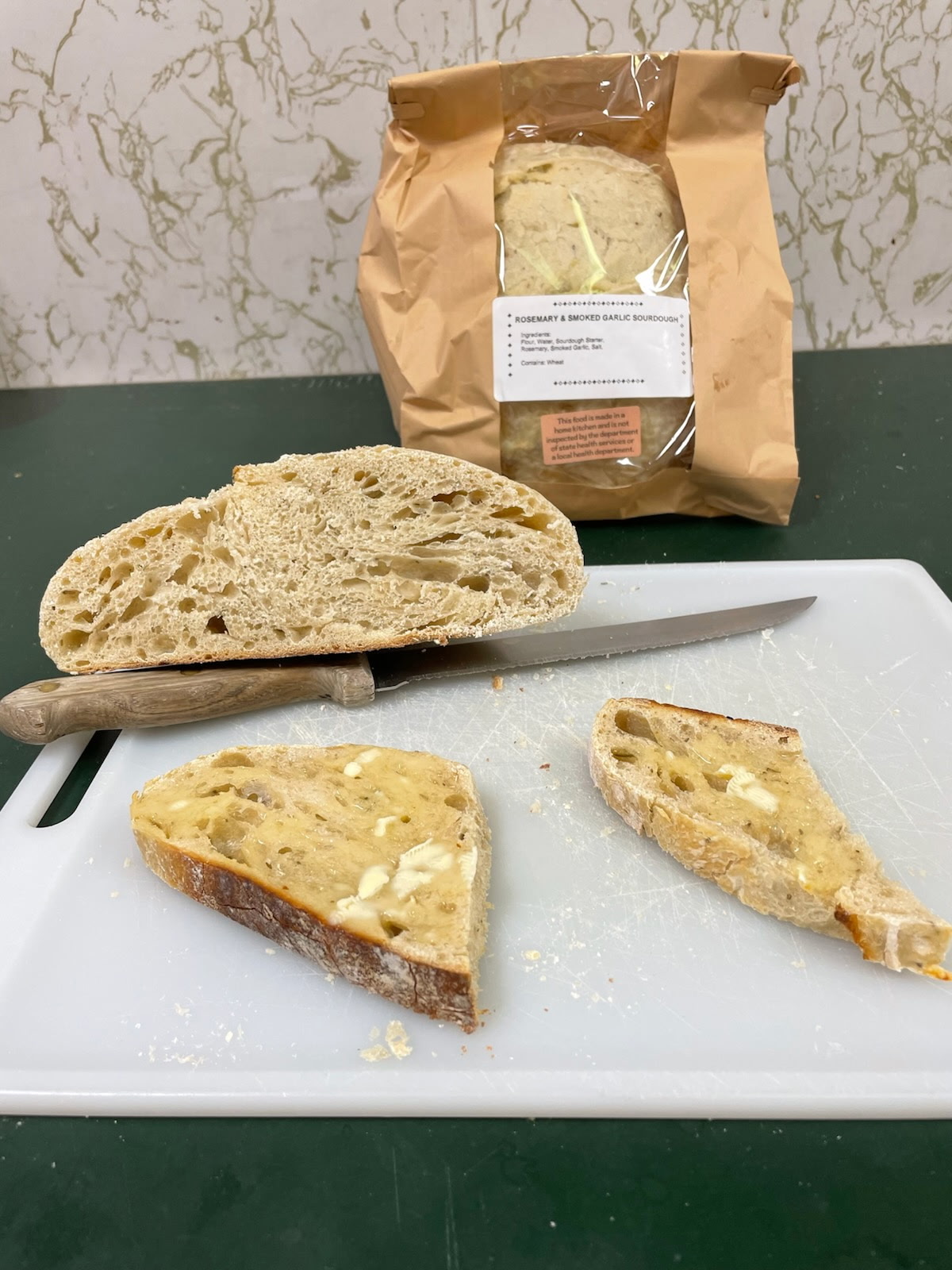 Rosemary and garlic sourdough sliced and served with butter.